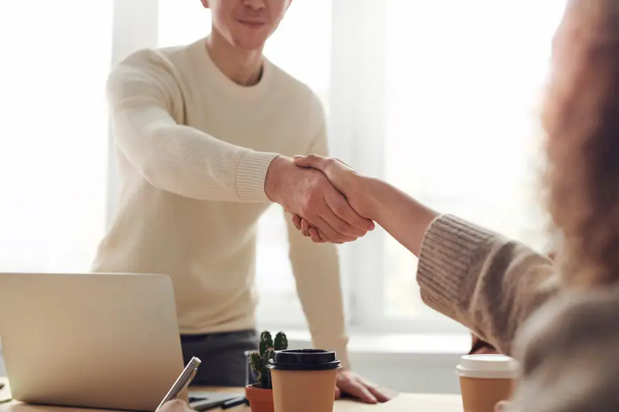 Team shaking hands in office